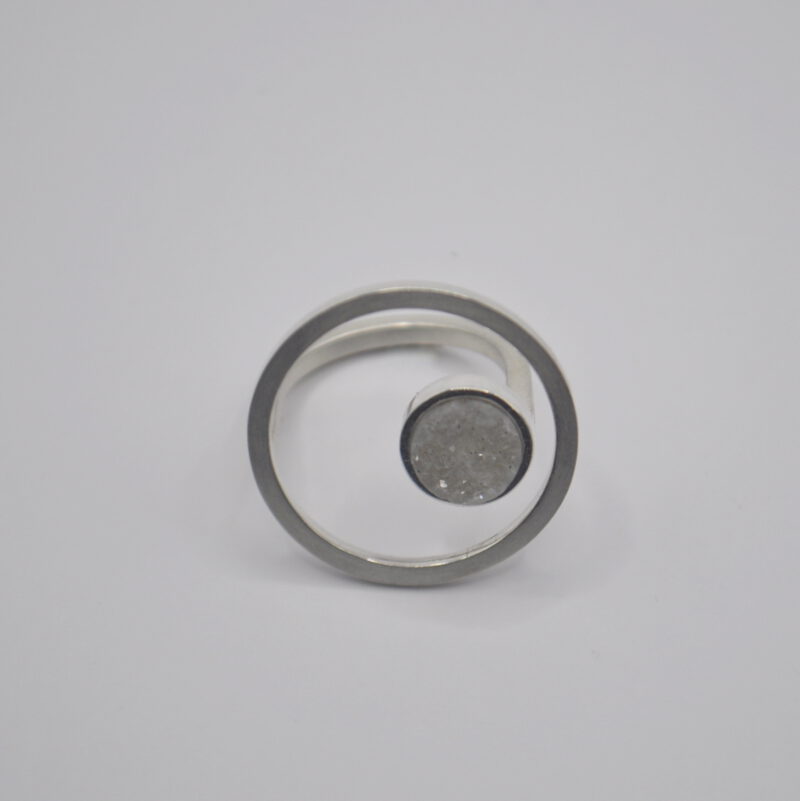 Ring mit Kreis aus Silber und weißem Kristall.