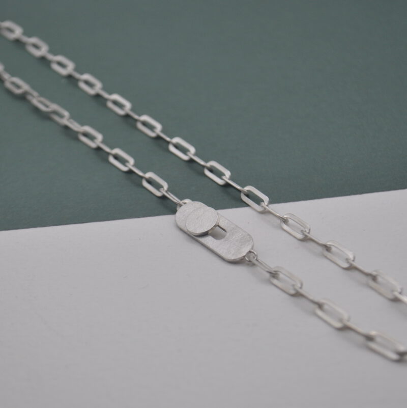 Silberne Kette aus ovalen Ösen mit einem Knopflochverschluss